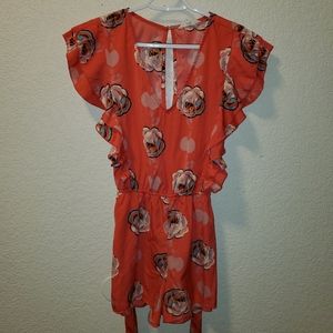 Coral romper in a pretty floral pattern